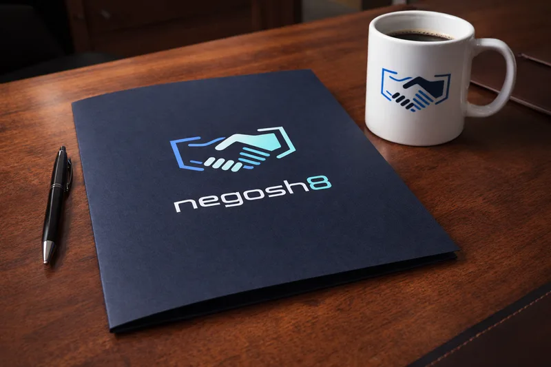 Navy folder with the negosh8 handshake logo on a wooden desk, beside a pen and a white mug with the same handshake